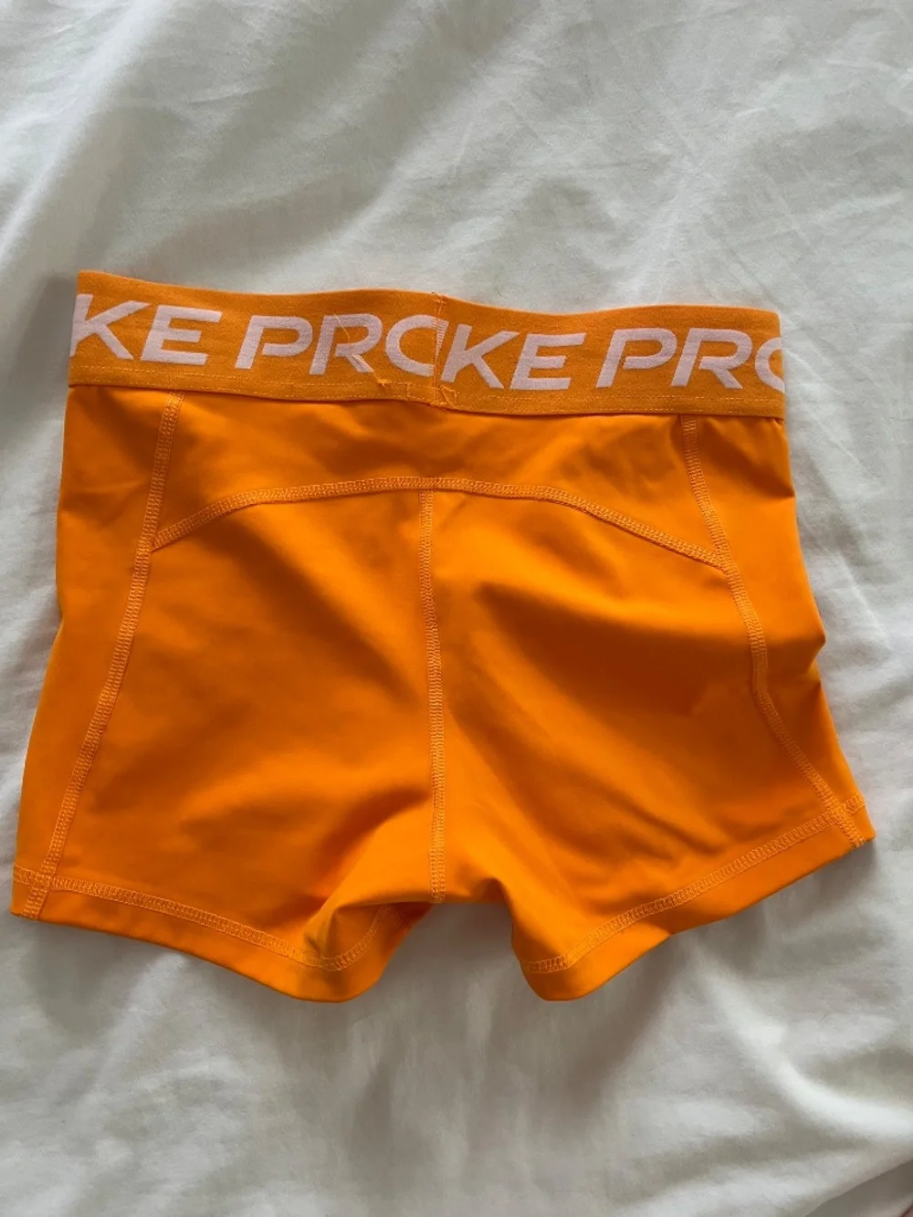 Orange Nike Pro shorts